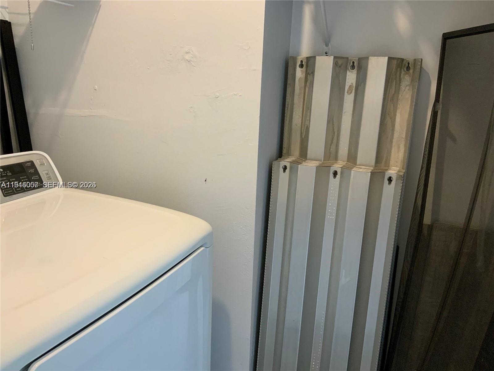 9920 Northwest 68th Place, Unit 110 Tamarac, FL 33321 - Photo 15 of 22 a room with a bed and a mirror