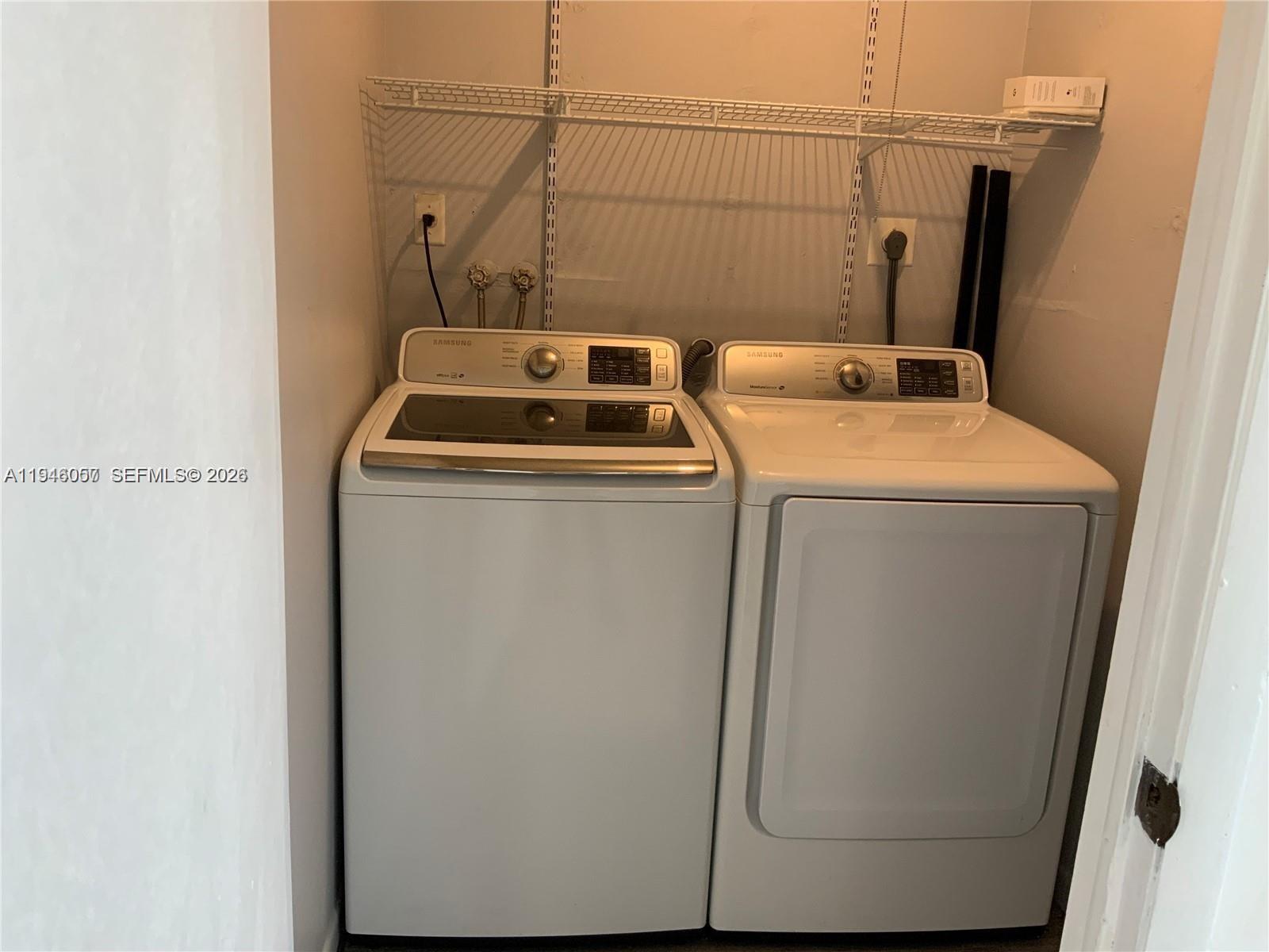 9920 Northwest 68th Place, Unit 110 Tamarac, FL 33321 - Photo 16 of 22 a utility room with dryer and washer