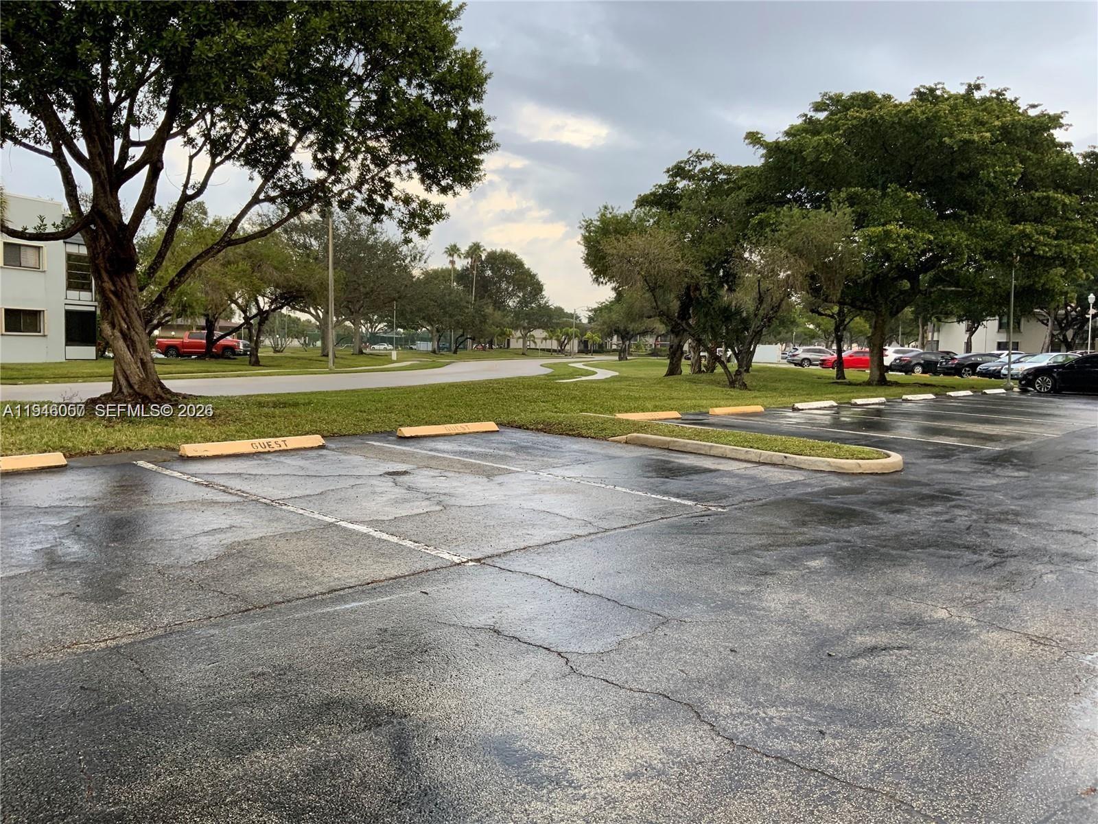 9920 Northwest 68th Place, Unit 110 Tamarac, FL 33321 - Photo 22 of 22 a view of swimming pool and trees in the background
