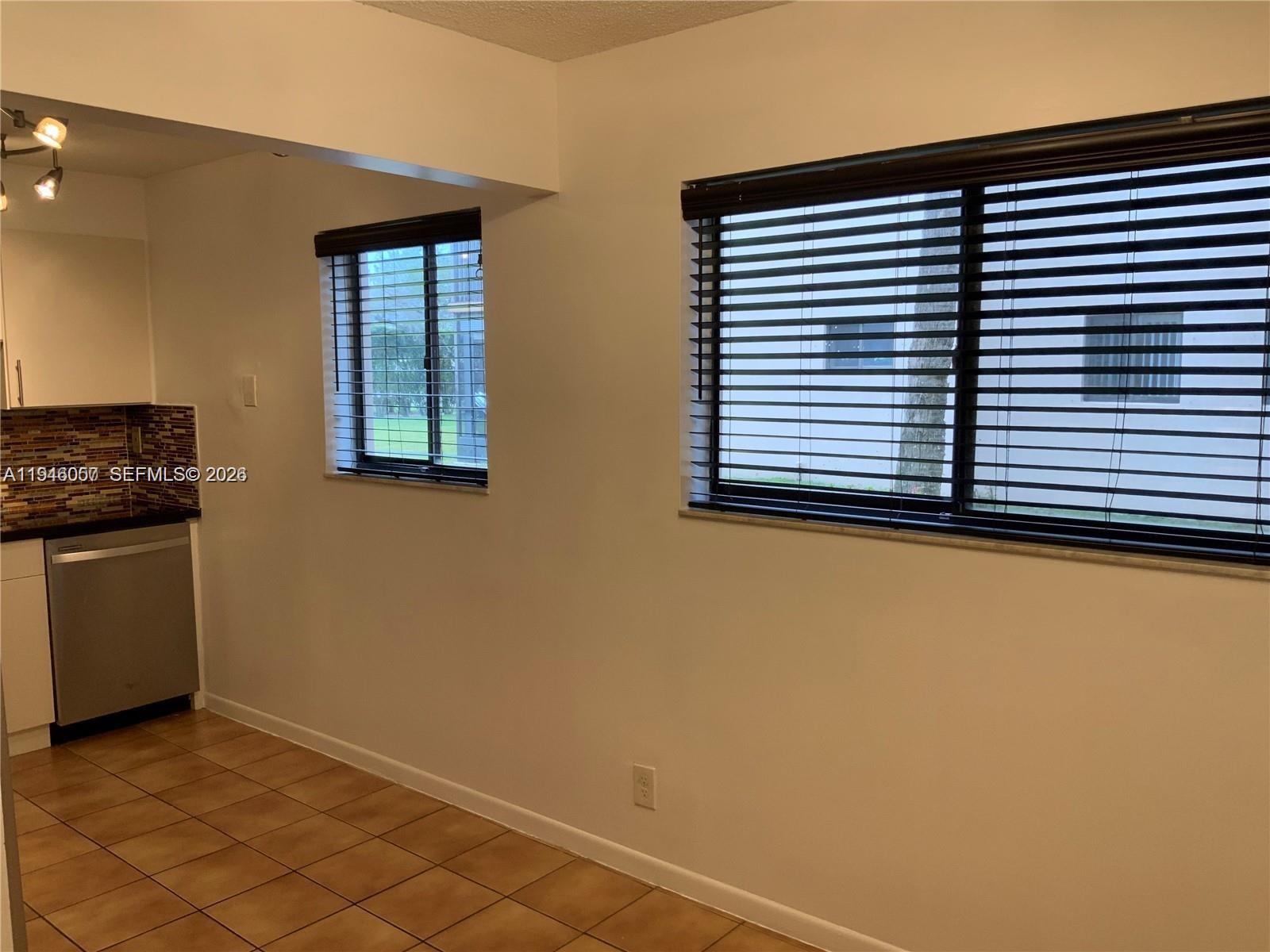 9920 Northwest 68th Place, Unit 110 Tamarac, FL 33321 - Photo 5 of 22 a view of a kitchen cabinets and a window