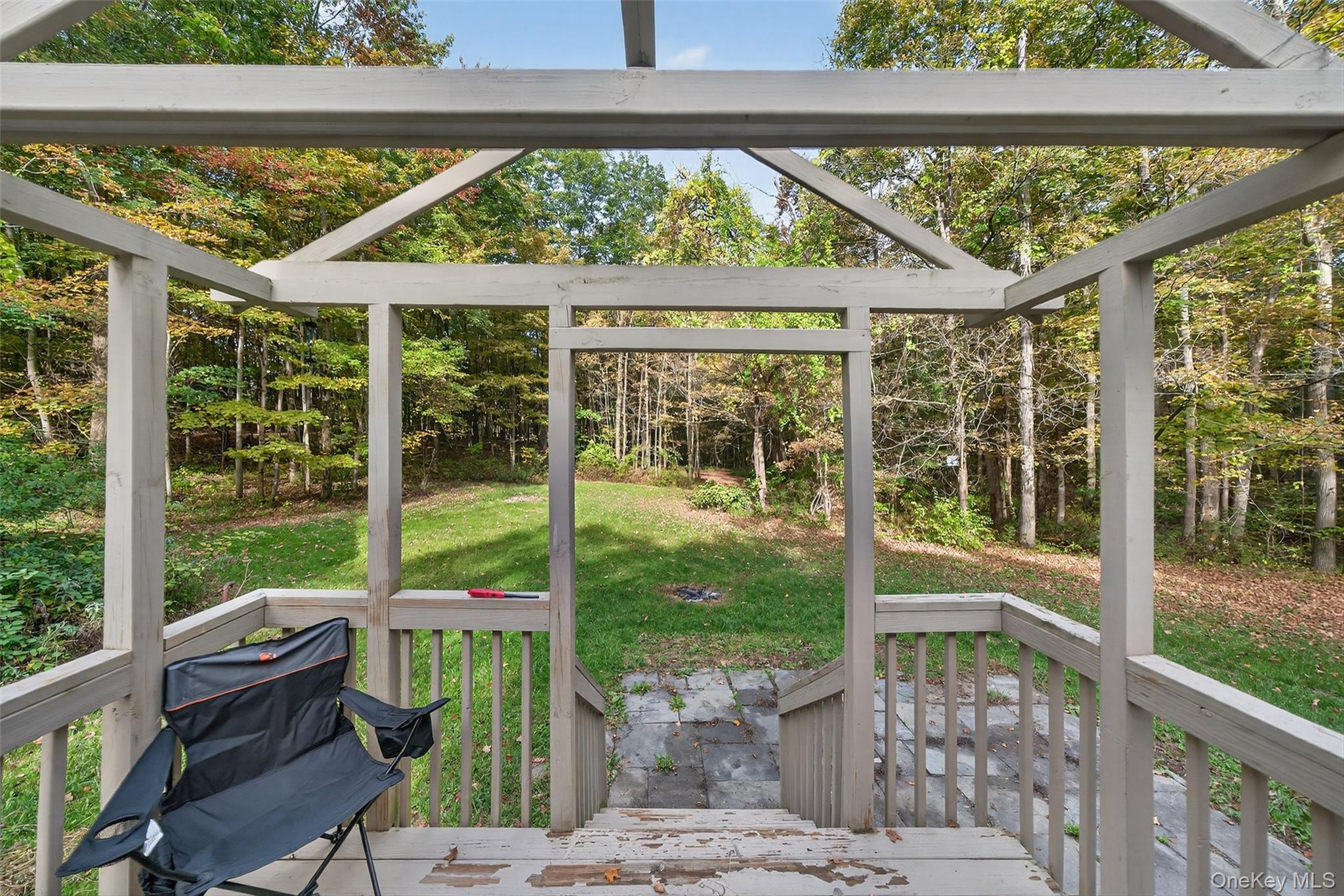 15 Nelson Road Monroe, NY 10950 - Photo 10 of 50 a view of a patio with table and chairs potted plants with wooden floor and fence