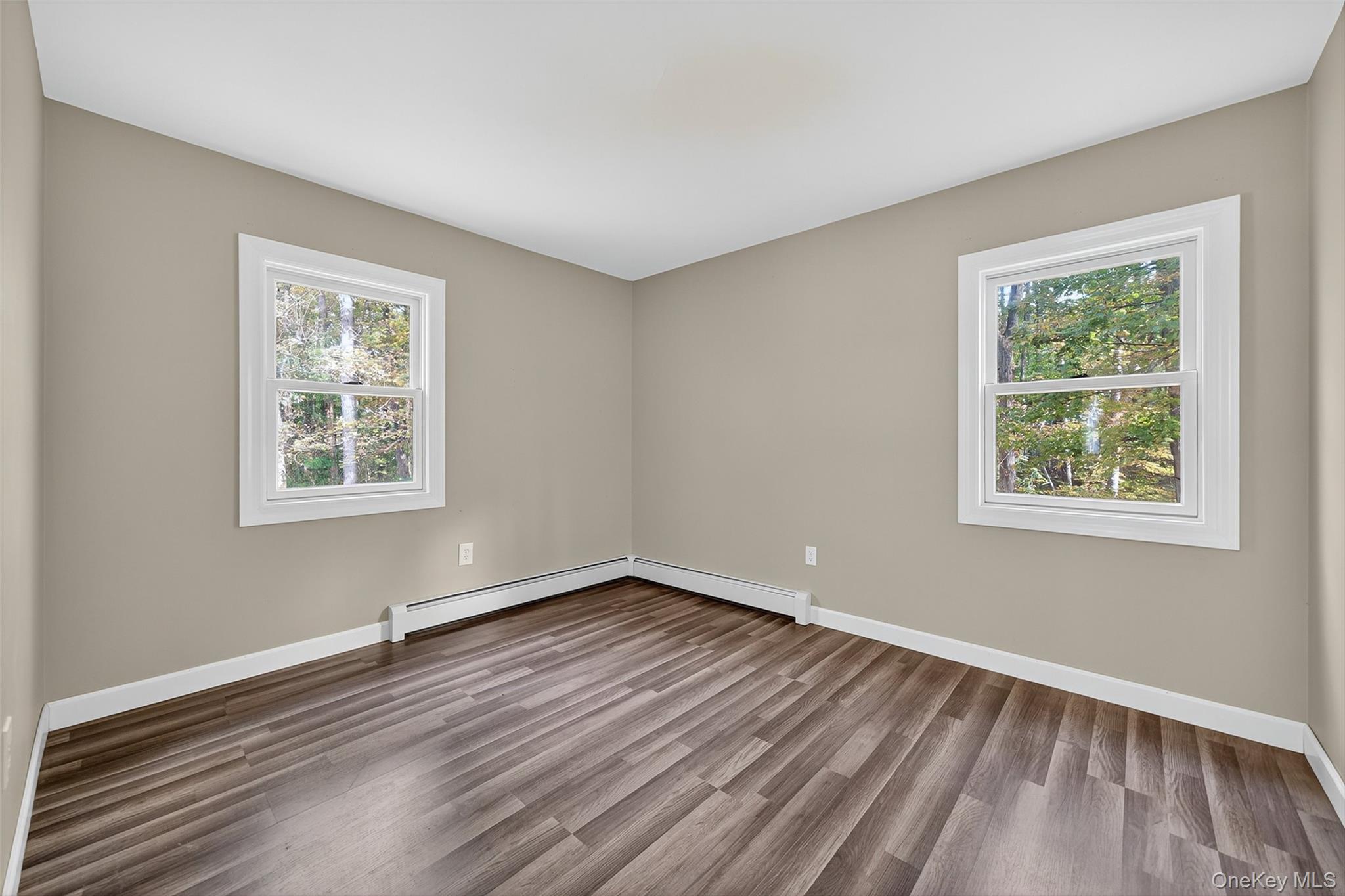 15 Nelson Road Monroe, NY 10950 - Photo 16 of 50 a view of an empty room with wooden floor and a window