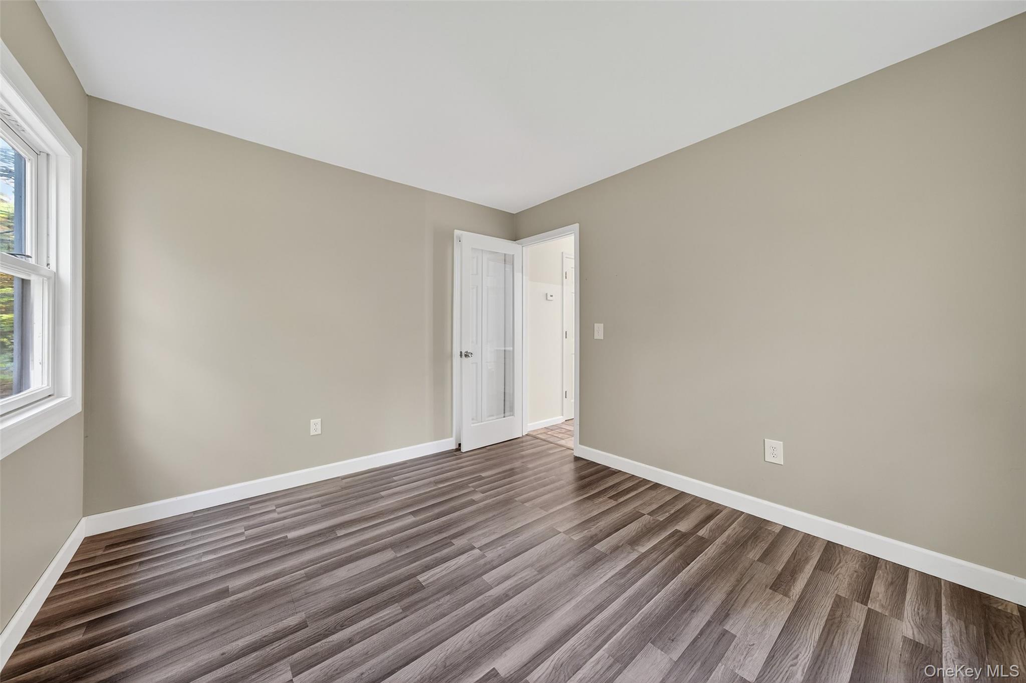 15 Nelson Road Monroe, NY 10950 - Photo 17 of 50 a view of an empty room with wooden floor and a window