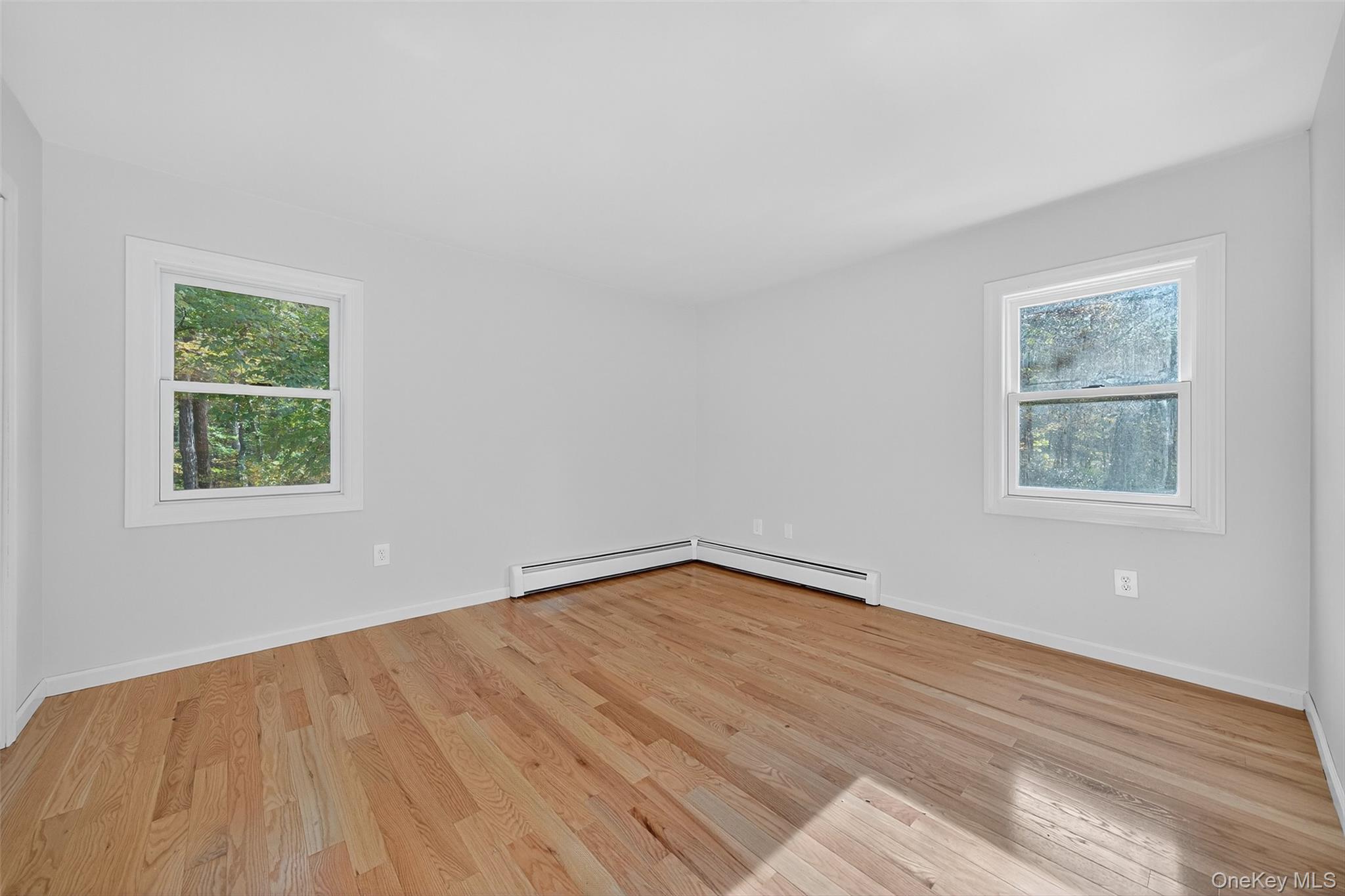 15 Nelson Road Monroe, NY 10950 - Photo 19 of 50 an empty room with wooden floor and windows