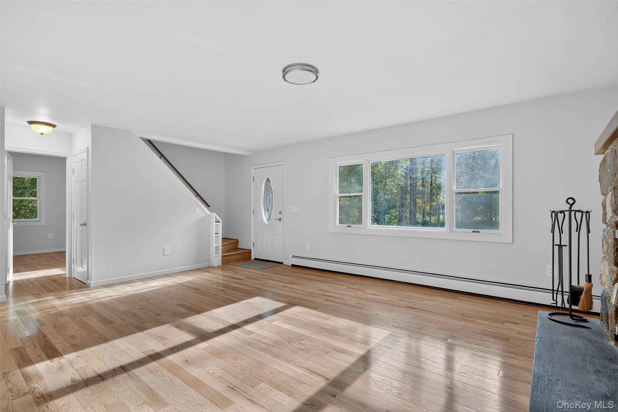 15 Nelson Road Monroe, NY 10950 - Photo 21 of 50 a view of an empty room with a window and wooden floor