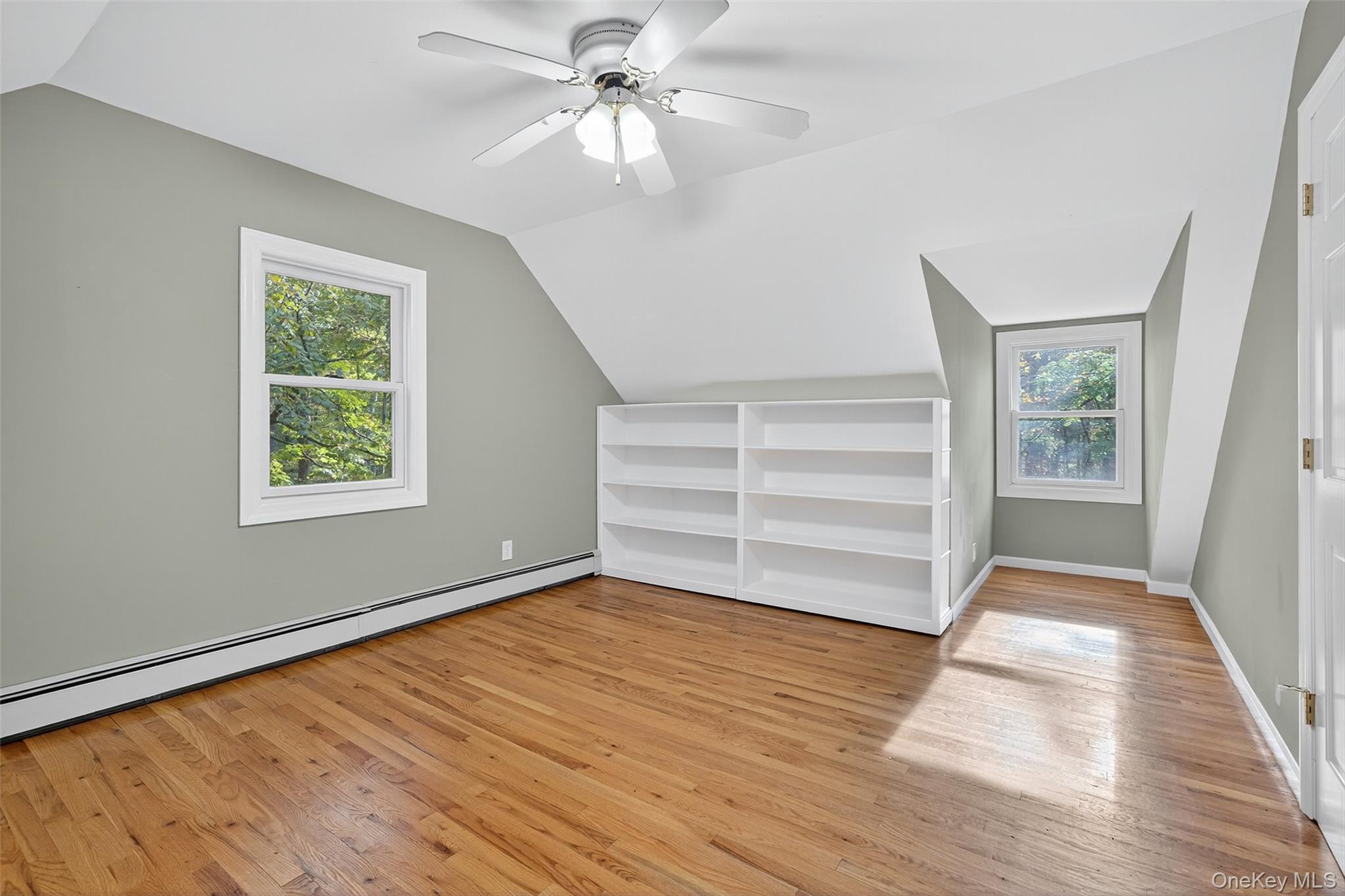 15 Nelson Road Monroe, NY 10950 - Photo 22 of 50 a view of an empty room with a window and wooden floor