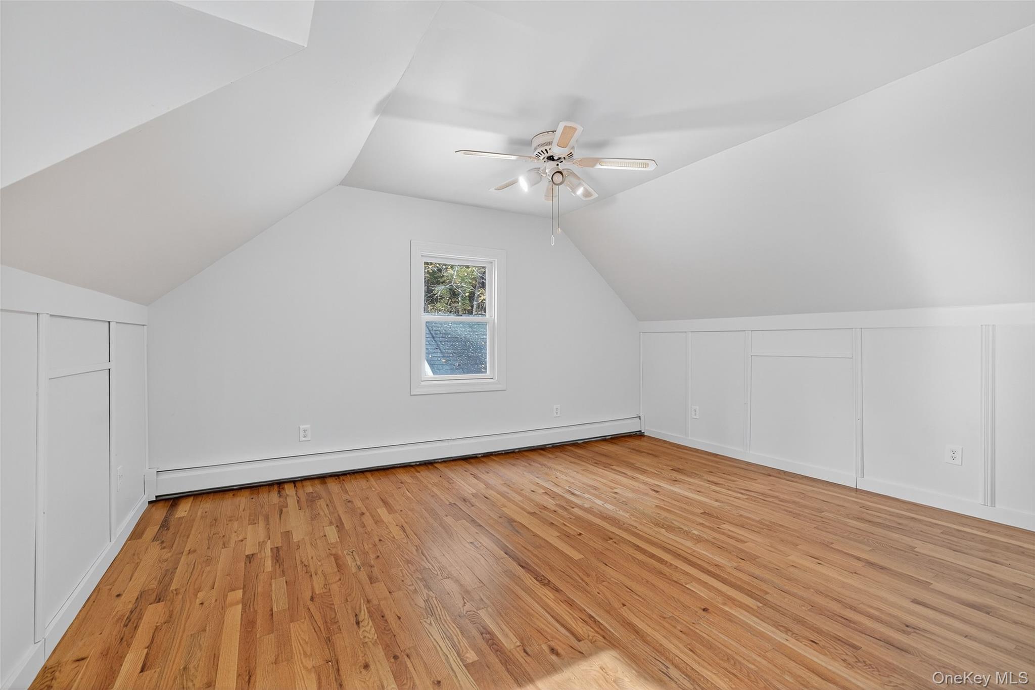15 Nelson Road Monroe, NY 10950 - Photo 25 of 50 an empty room with wooden floor fan and windows