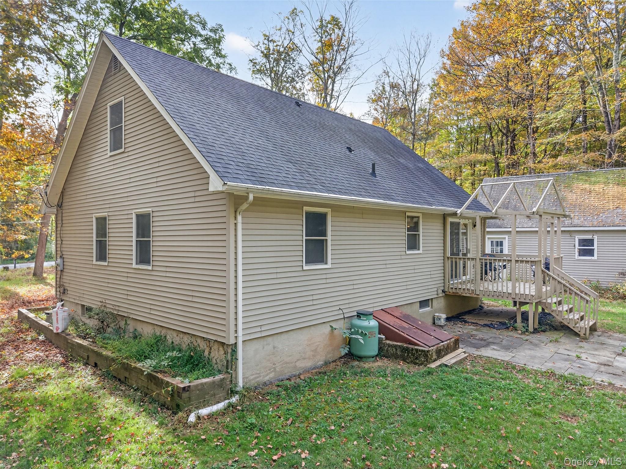 15 Nelson Road Monroe, NY 10950 - Photo 28 of 50 a view of a house with a yard chairs and a table under an umbrella