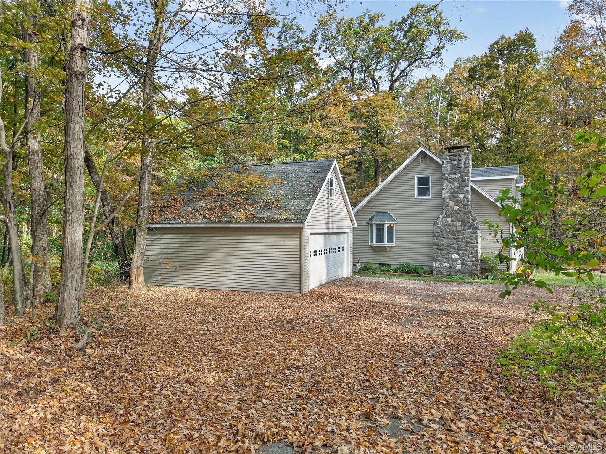 15 Nelson Road Monroe, NY 10950 - Photo 29 of 50 a front view of a house with a yard and garage