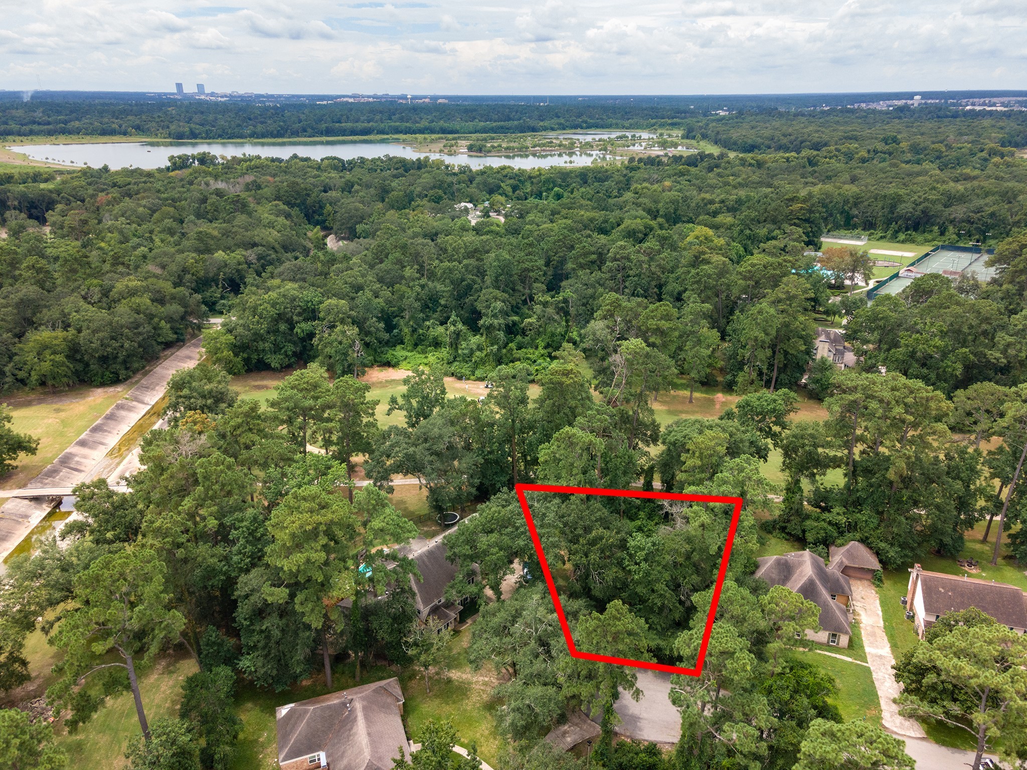 135 Jeb Stuart Lane Conroe, TX 77302 - Photo 16 of 16 a view of a lake with a house