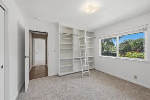 a view of a swimming pool and trees in the background