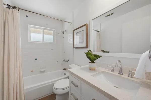 a view of a tennis court with a small yard