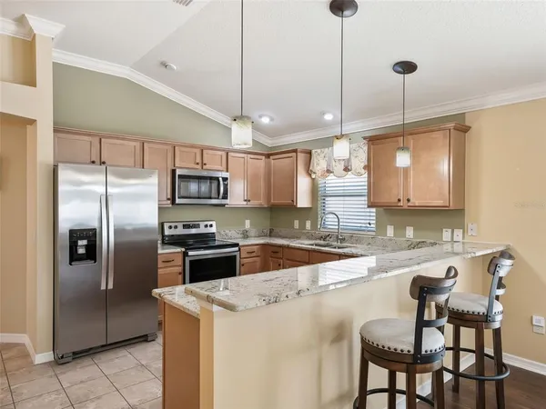 a living room with fireplace furniture and a chandelier