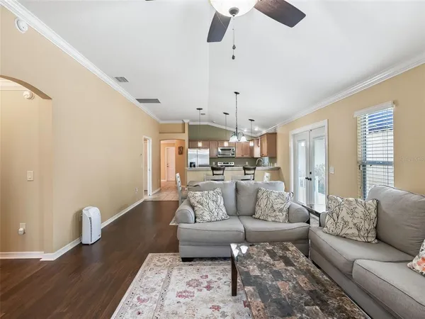 a bedroom with furniture and a large window