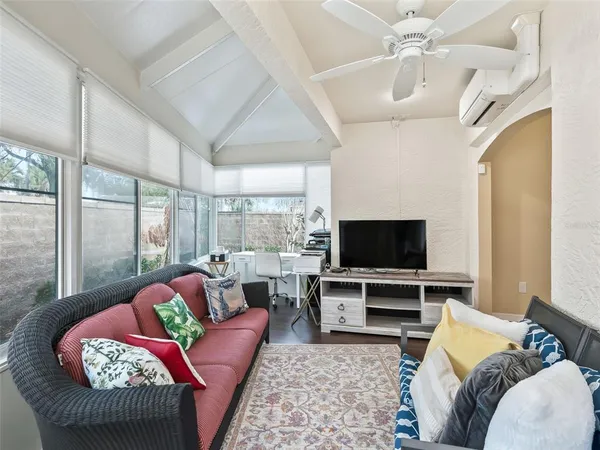 a living room with furniture and wooden floor