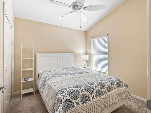 a bedroom with a large bed and a chandelier