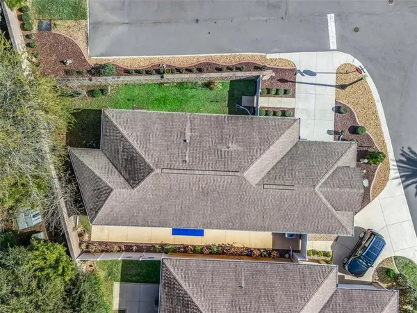 an aerial view of a house with a yard
