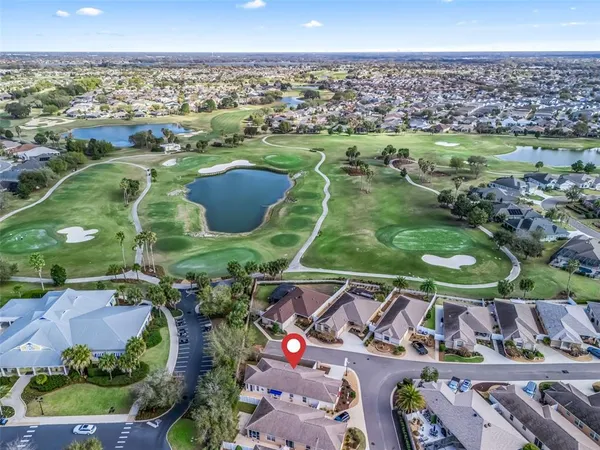 an aerial view of a houses with a lake
