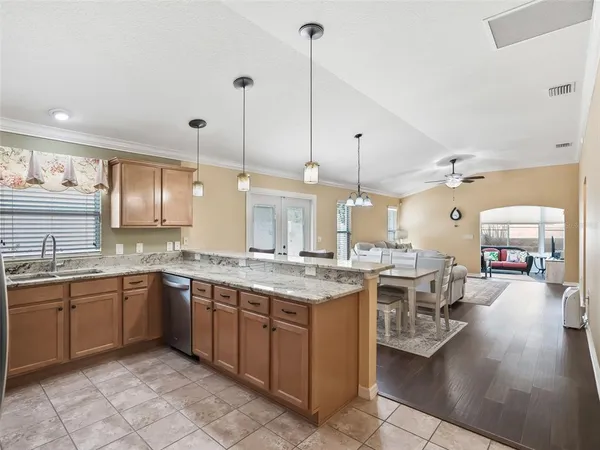 a kitchen with stainless steel appliances granite countertop a sink and a stove