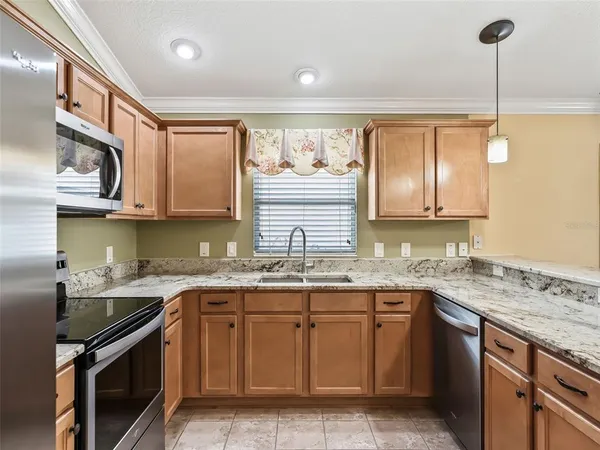 a kitchen with stainless steel appliances granite countertop a sink and stove top oven