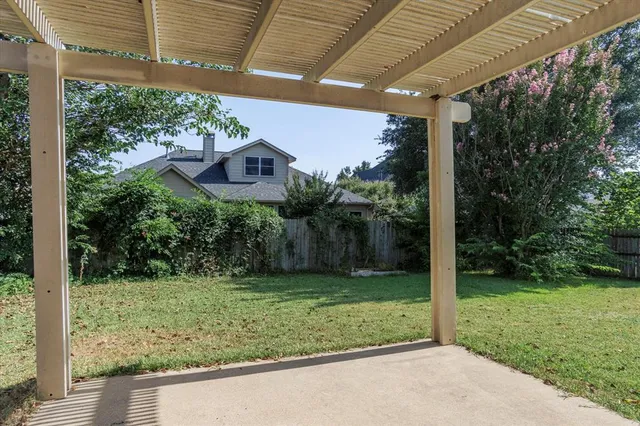 a view of a house with backyard and porch