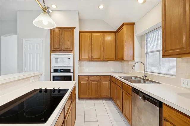 a kitchen with sink and cabinets
