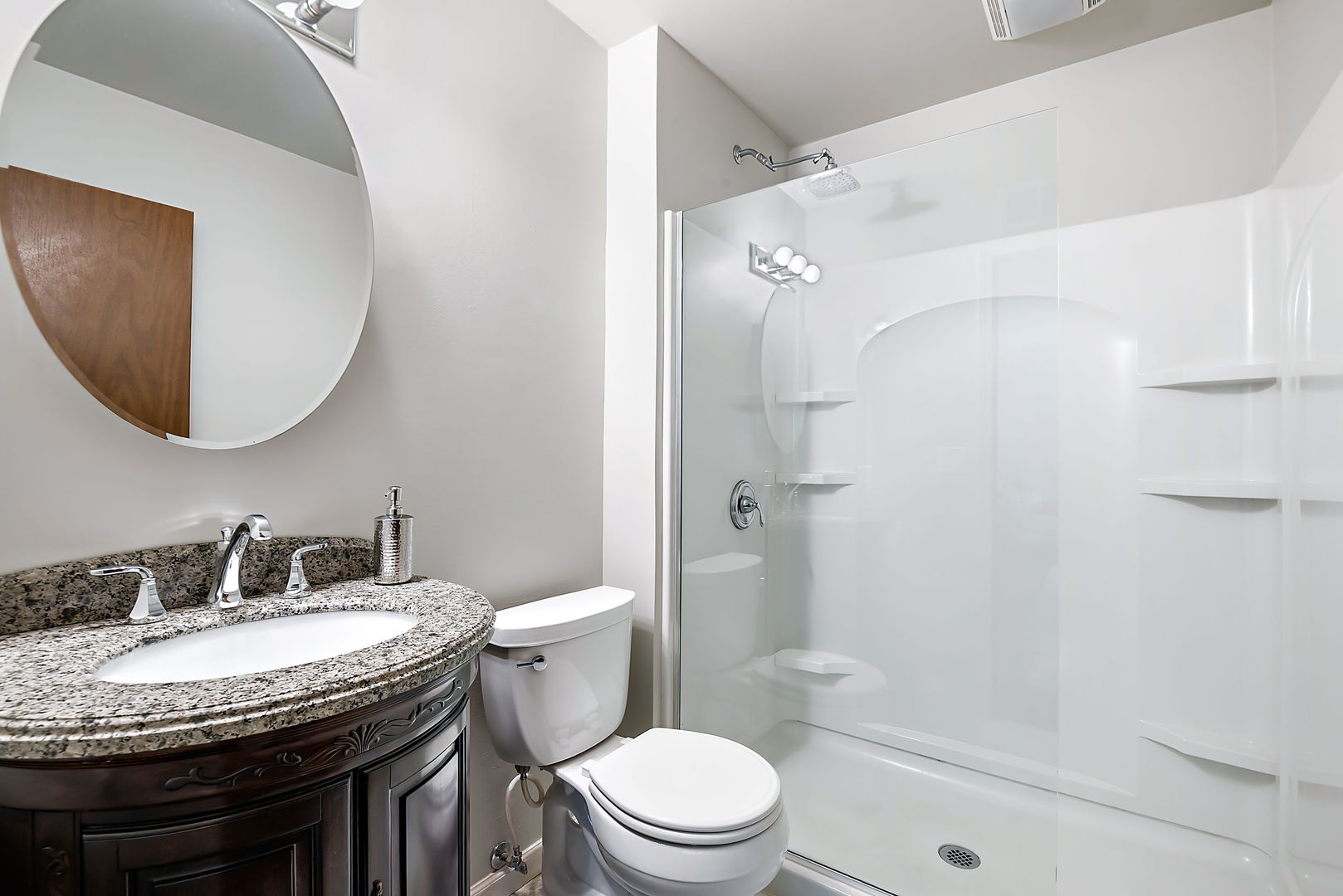 110 Bridgeport Lane Geneva, IL 60134 - Photo 17 of 27 a bathroom with a granite countertop sink a toilet a mirror and shower