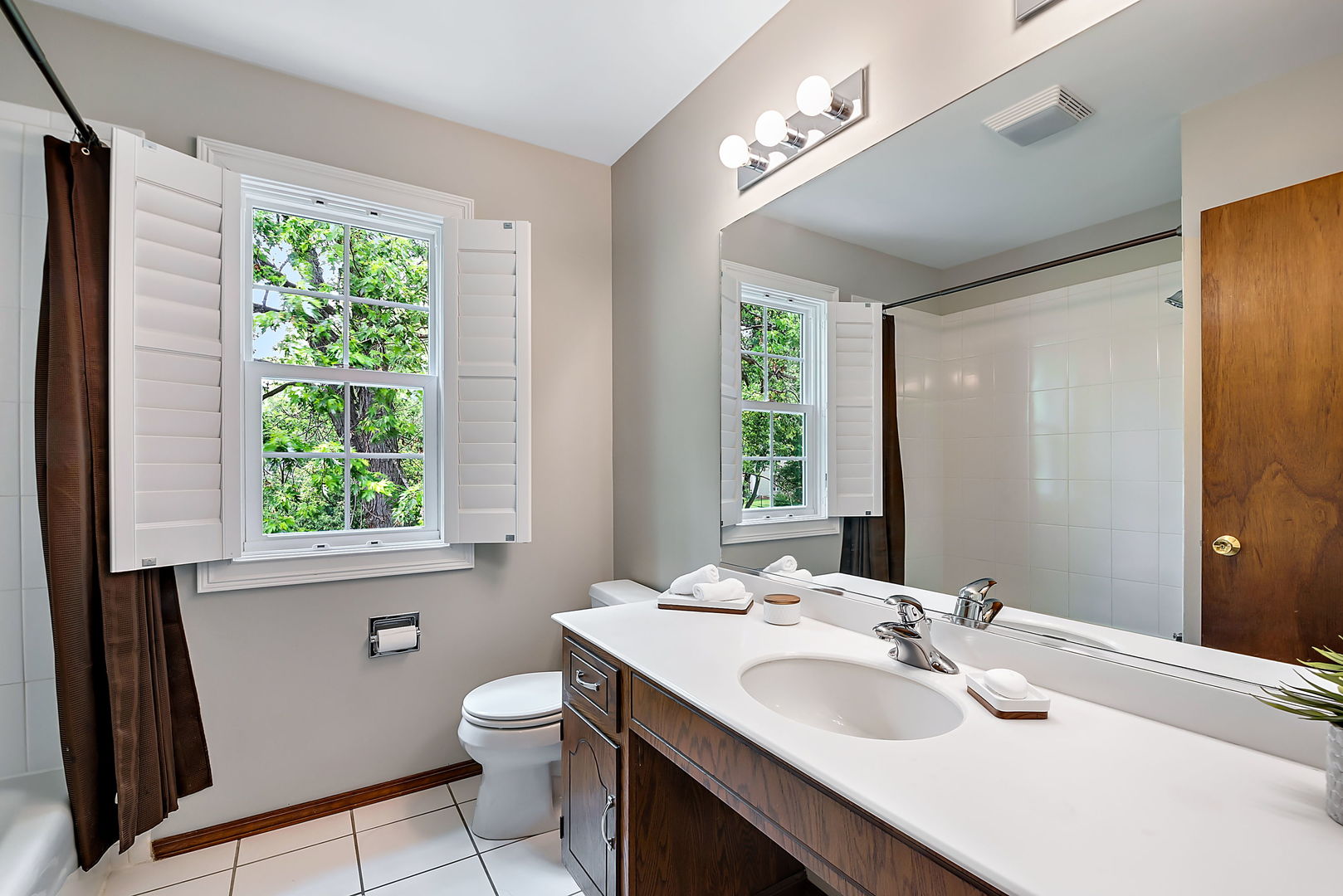 110 Bridgeport Lane Geneva, IL 60134 - Photo 21 of 27 a bathroom with a granite countertop sink toilet a large mirror next to a window