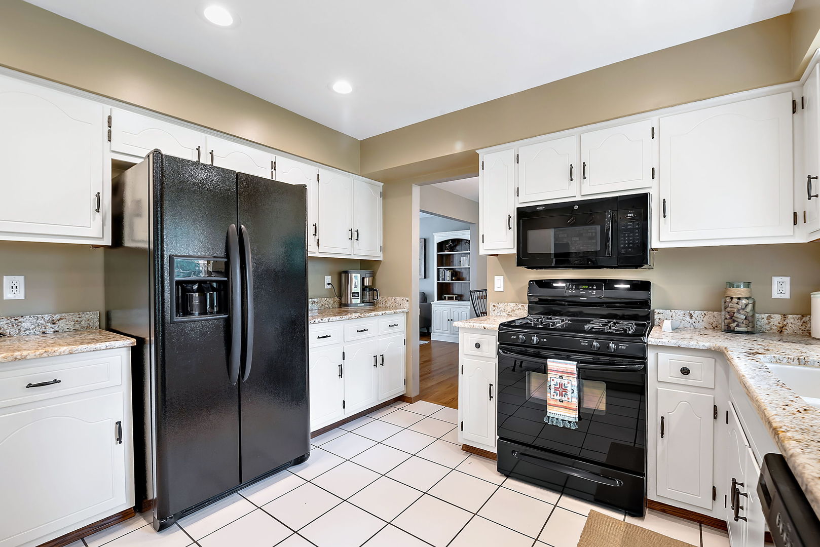110 Bridgeport Lane Geneva, IL 60134 - Photo 7 of 27 a kitchen with stainless steel appliances kitchen island granite countertop a refrigerator stove and microwave