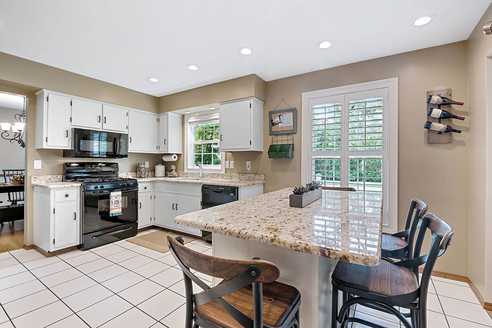 110 Bridgeport Lane Geneva, IL 60134 - Photo 8 of 27 a kitchen with kitchen island granite countertop wooden cabinets and stainless steel appliances