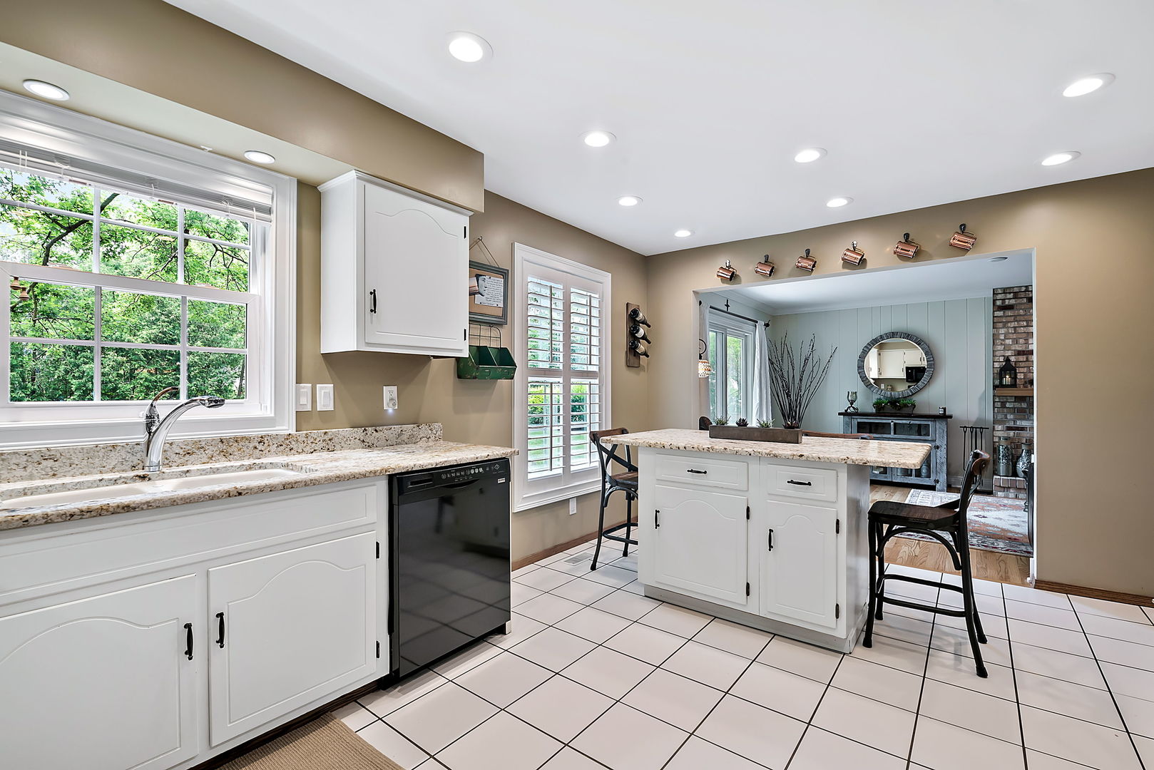 110 Bridgeport Lane Geneva, IL 60134 - Photo 10 of 27 a kitchen with a sink and chairs