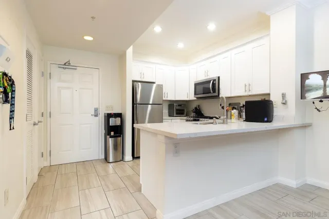 a kitchen with stainless steel appliances a refrigerator sink and microwave