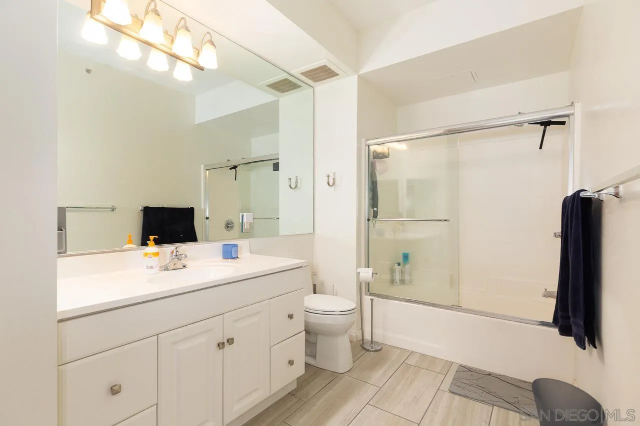 450 J Street, Unit 3151 San Diego, CA 92101 - Photo 6 of 13 a bathroom with a sink a toilet and shower