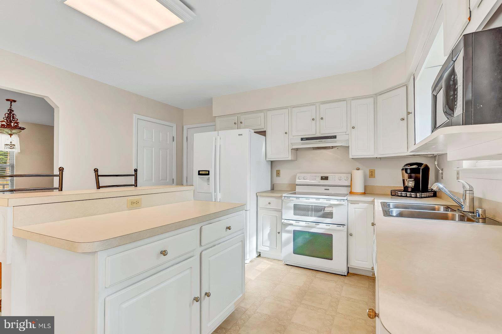 6815 Mackall Road St. Leonard, MD 20685 - Photo 11 of 38 a kitchen with cabinets stainless steel appliances and sink