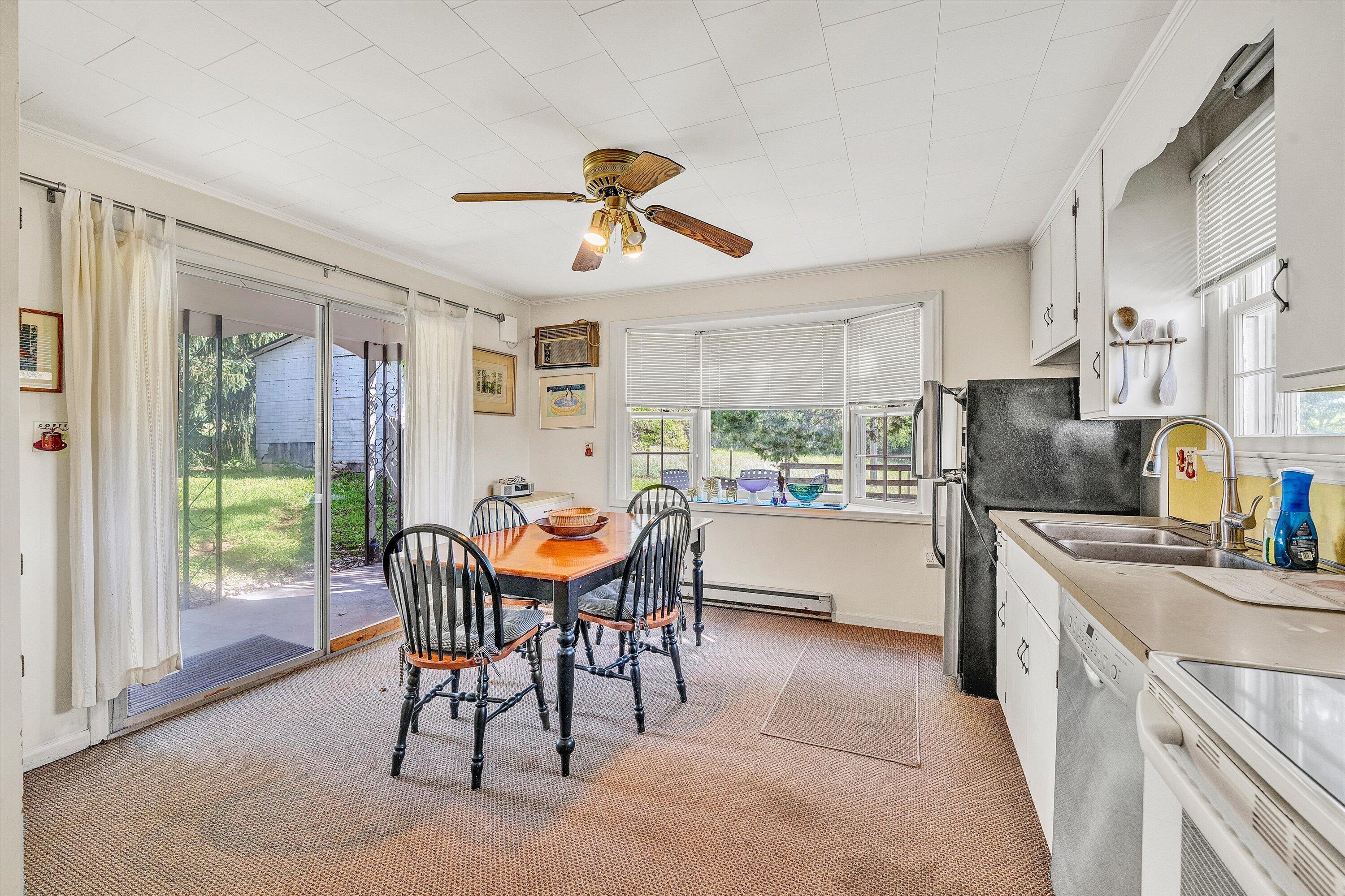 5328 White House Road Moneta, VA 24121 - Photo 10 of 39 a kitchen with stainless steel appliances a table and chairs in it