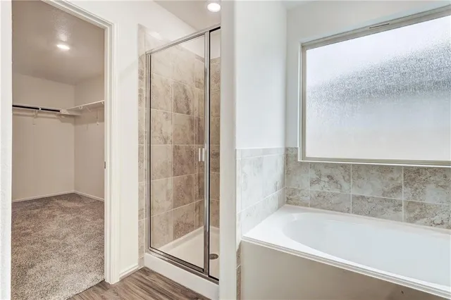 a bathroom with a bathtub and a shower