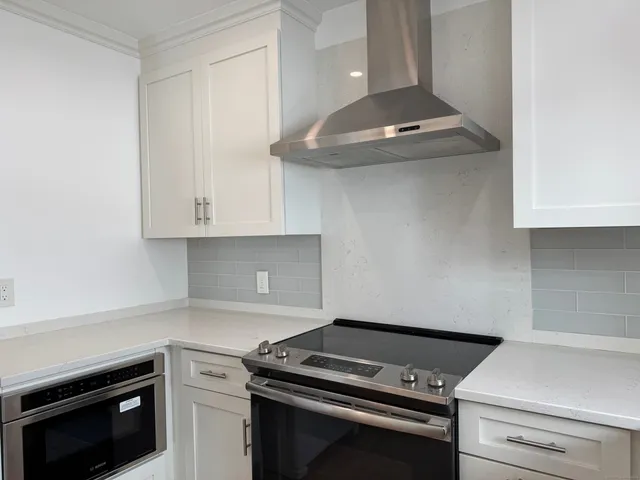 a kitchen with granite countertop a stove and a sink