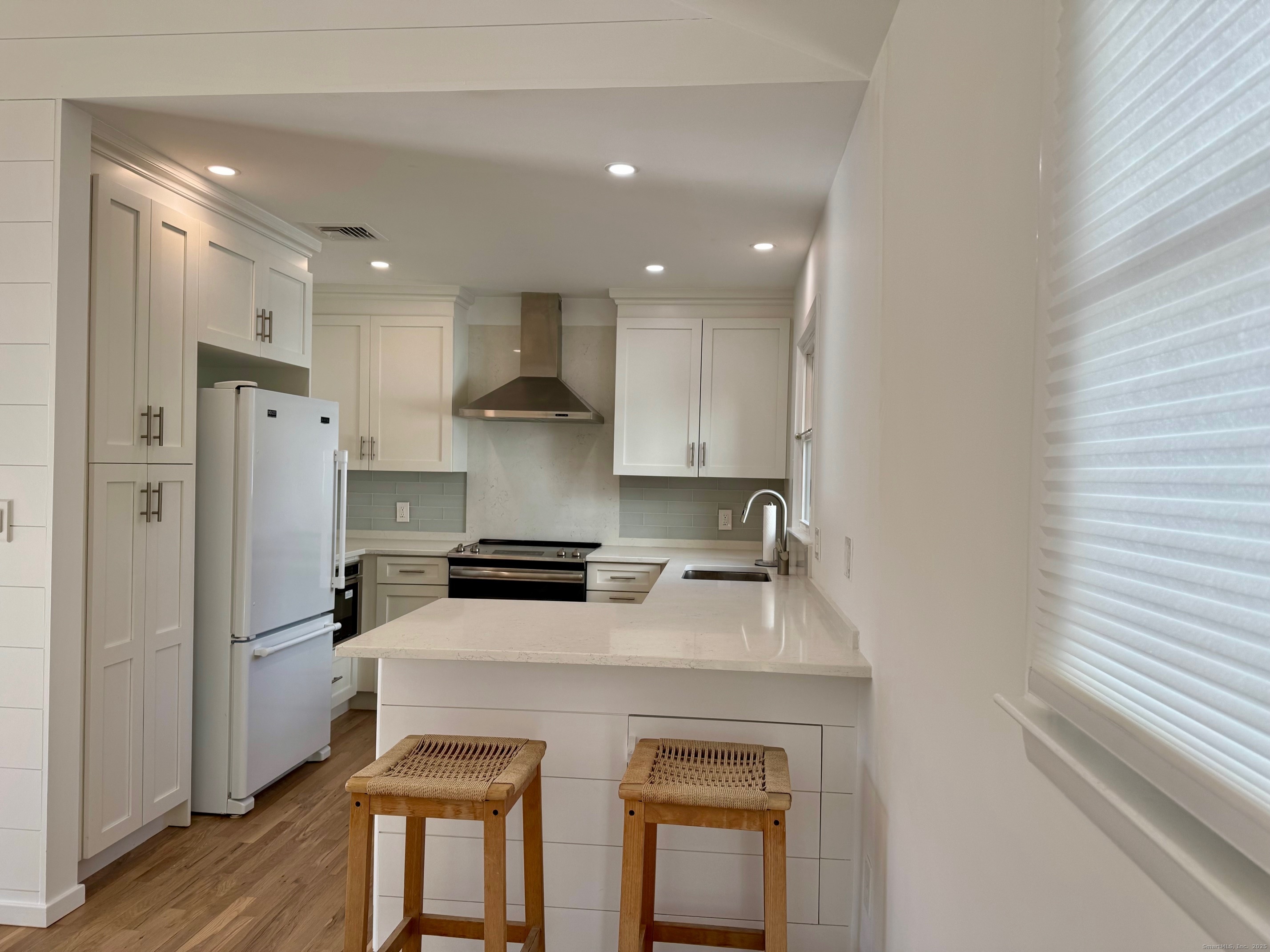 15 Sunwich Road Norwalk, CT 06853 - Photo 10 of 33 a kitchen with a stove a refrigerator and a sink