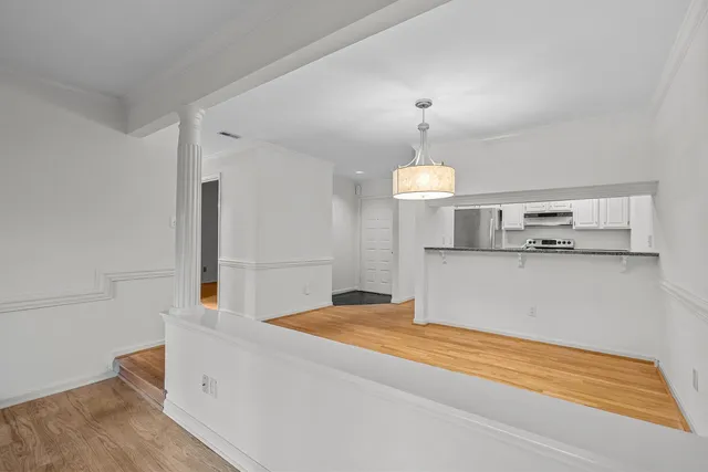 a view of a kitchen with a sink and dishwasher wooden floor