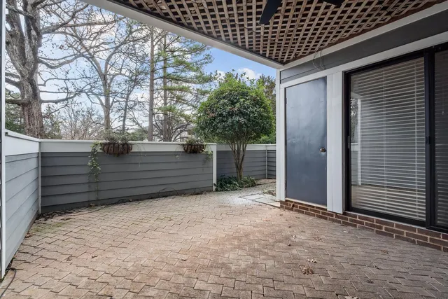a view of patio with table and chairs and potted plants