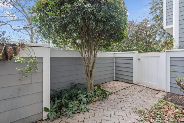 a front view of a residential apartment building with a yard