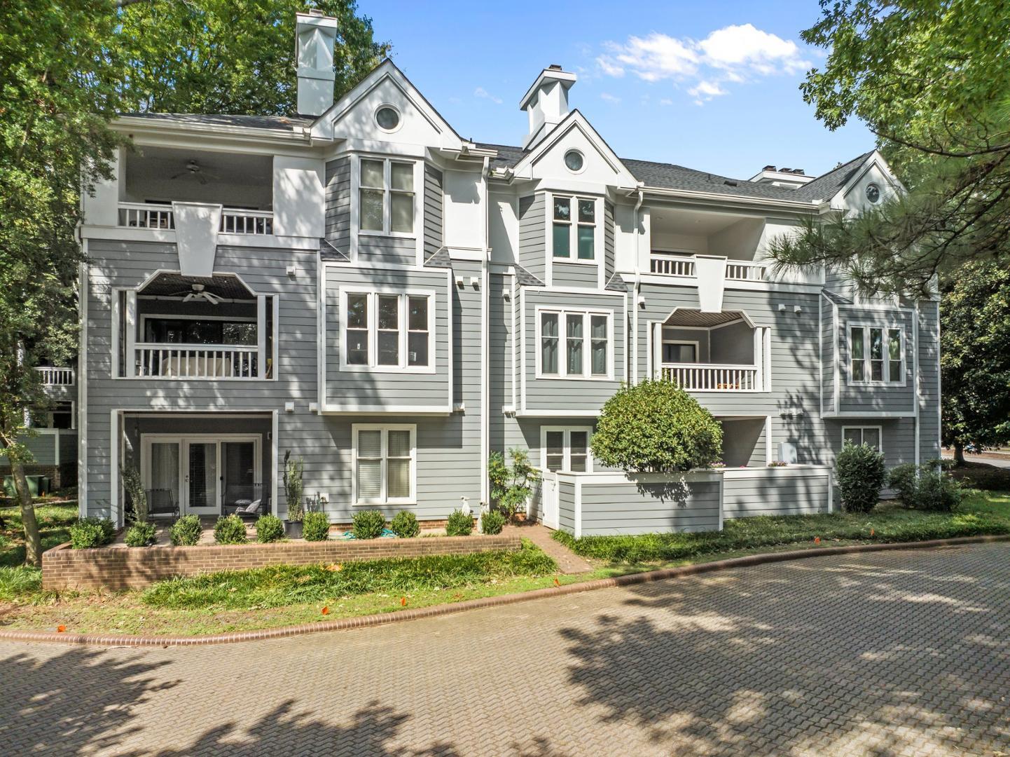 700 Bishops Park Drive, Unit 102 Raleigh, NC 27605 - Photo 32 of 56 a front view of a residential apartment building with a yard
