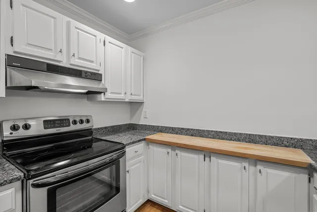 a view of a refrigerator in kitchen and wooden floor