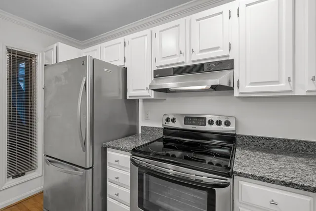 a kitchen with granite countertop a sink and cabinets
