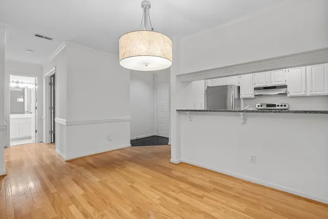 a kitchen with granite countertop a sink and cabinets