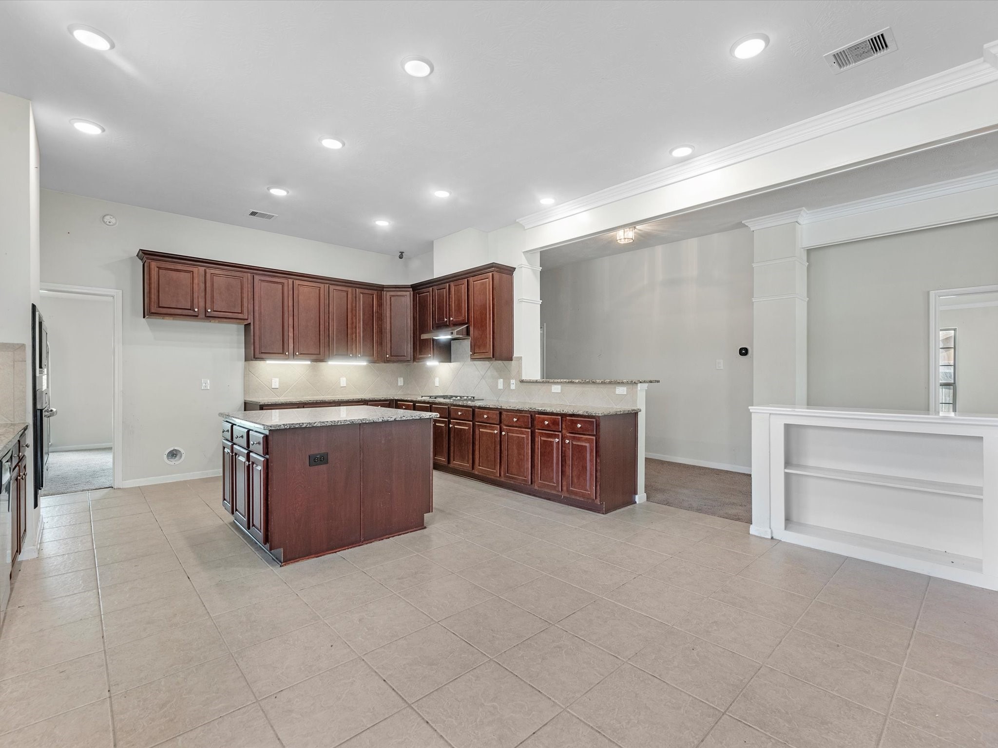 38 Palmero Way Manvel, TX 77578 - Photo 14 of 43 a kitchen with stainless steel appliances granite countertop a stove a sink and a refrigerator