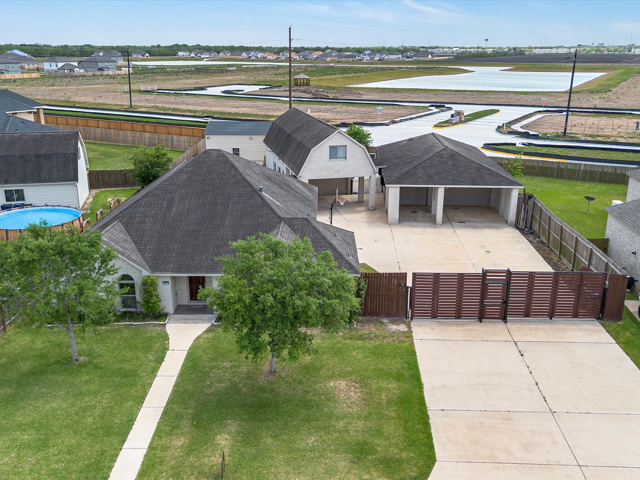38 Palmero Way Manvel, TX 77578 - Photo 2 of 43 a view of a swimming pool with a lounge chairs