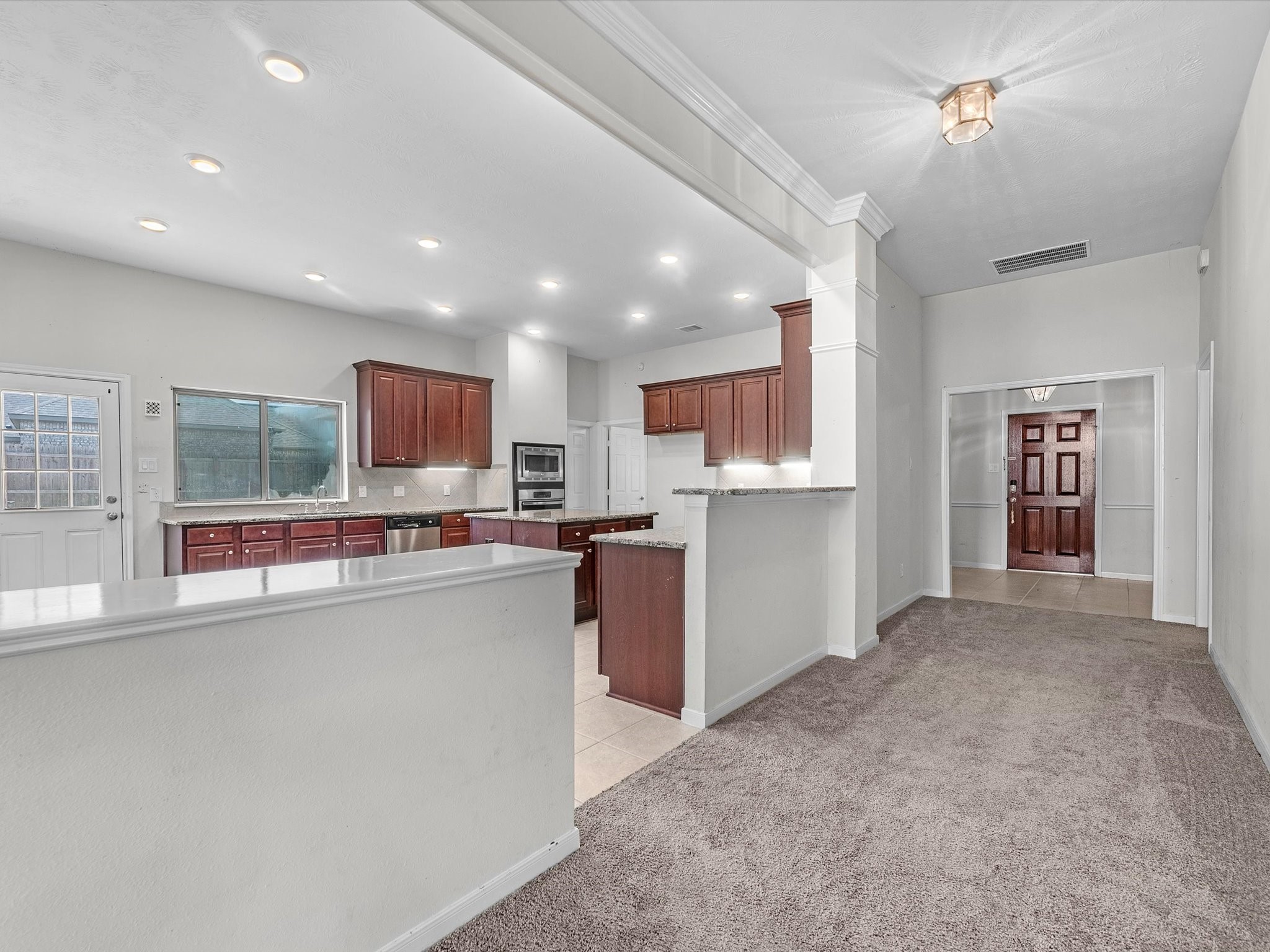 38 Palmero Way Manvel, TX 77578 - Photo 9 of 43 a open kitchen with stainless steel appliances granite countertop a refrigerator and a stove top oven