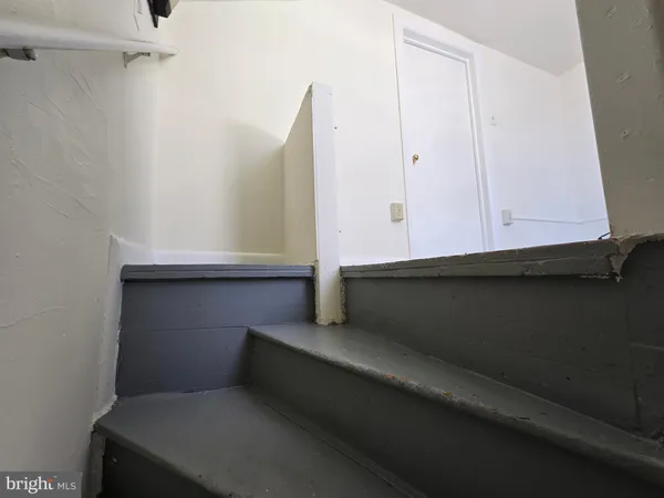 a living room with furniture and a ceiling fan