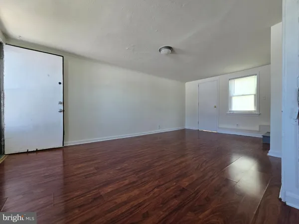 a view of wooden floor and windows in a room